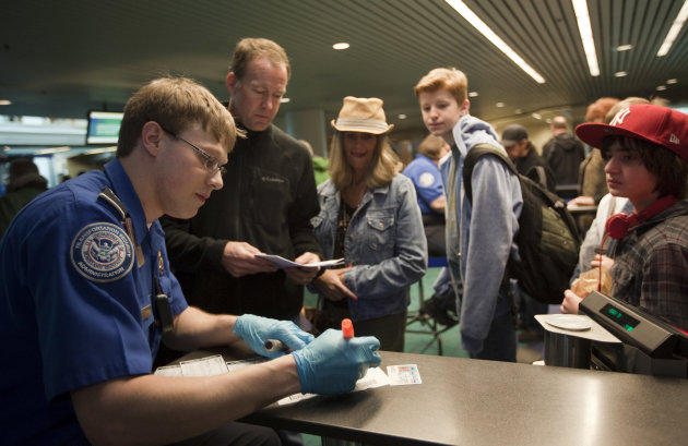PORTLAND, OR - MARCH 19:  Passengers line up to a Transportation Security Administration (TSA) officer to go through airport security at Portland International Airport (PDX) March 19, 2012 in Portland, Oregon. The TSA has modified screening procedures for passengers 75 and older and was implemented at four airports nationwide as a part of a pilot program.  (Photo by Natalie Behring/Getty Images)