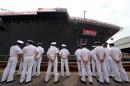 Crew members of Japan's warship, the DDH183 Izumo, stand alongside the vessel during a launch ceremony in Yokohama on August 6, 2013