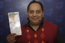 This undated photo provided by the Illinois Lottery shows Urooj Khan, 46, of Chicago's West Rogers Park neighborhood, posing with a winning lottery ticket. The Cook County medical examiner said Monday, Jan. 7, 2013, that Khan was fatally poisoned with cyanide July 20, 2012, a day after he collected nearly $425,000 in lottery winnings. (AP Photo/Illinois Lottery)