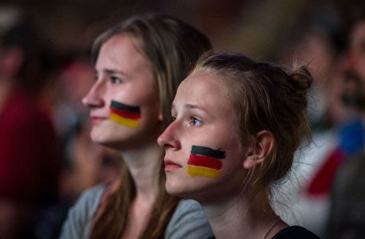 German football fans watch from the Warsaw Fanzone