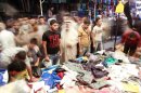 People shop for new clothes ahead of the upcoming Muslim holiday of Eid al-Adha in Baghdad, Iraq, Wednesday, Oct. 24, 2012. It is part of tradition to buy and wear new clothes during Eid al-Adha or the Feast of Sacrifice. (AP Photo/Hadi Mizban)