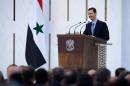 In this photo released by the Syrian official news agency SANA, Syria's President Bashar Assad laughs as he addresses a speech shortly after he was sworn in for his third seven-year term in Damascus, Syria, Wednesday, July 16, 2014. Proclaiming the Syrian people winners in a "dirty war" waged by outsiders, Assad was sworn in on Wednesday for a third seven-year term despite the bloody civil war ignited by a mass uprising against his rule. (AP Photo/SANA)