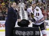 NHL Commissioner Gary Bettman, left, and Chicago Blackhawks captain Jonathan Toews pose with the Stanley Cup after the Blackhawks beat the Boston Bruins 3-2 in Game 6 of the NHL hockey Stanley Cup Finals Monday, June 24, 2013, in Boston. (AP Photo/Elise Amendola)