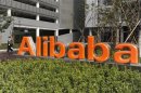 A security guard walks past a logo of Alibaba (China) Technology Co. Ltd at its headquarters on the outskirts of Hangzhou, Zhejiang province March 16, 2010.