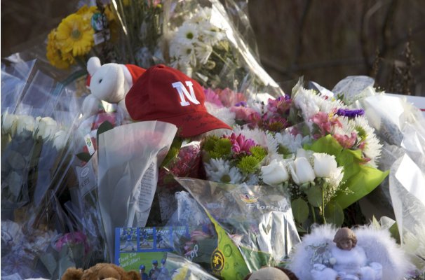 Flowers, stuffed animals and baseball hats are among items left at a makeshift memorial at the Sandy Hook Elementary School in Newtown, Connecticut
