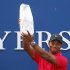 Woods lifts The Players Championship trophy in the air after winning the PGA golf tournament in Ponte Vedra Beach