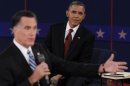 U.S. President Obama listens as Republican presidential nominee Romney answers a question during the second presidential debate in Hempstead