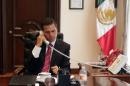 This picture released by the Mexican Presidency shows President Enrique Pena Nieto speaking on the phone with his Egyptian counterpart Abdel Fattah Al-Sisi, at the Los Pinos Residence in Mexico City, September 15, 2015