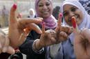 Egyptian women show their inked fingers after casting their votes at a polling station in Cairo, Tuesday, Jan. 14, 2014. Egyptians are voting on a draft for their country's new constitution that represents a key milestone in a military-backed roadmap put in place after President Mohammed Morsi was overthrown in a popularly backed coup last July. (AP Photo/Amr Nabil)