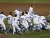 UCLA players pile up after defeating Mississippi State 8-0 in Game 2 to win the championship in the NCAA College World Series baseball finals Tuesday, June 25, 2013, in Omaha, Neb. (AP Photo/Nati Harnik)