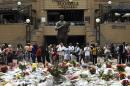 South Africans pay respect to former South African President Nelson Mandela on Mandela Square in Johannesburg on December 8, 2013