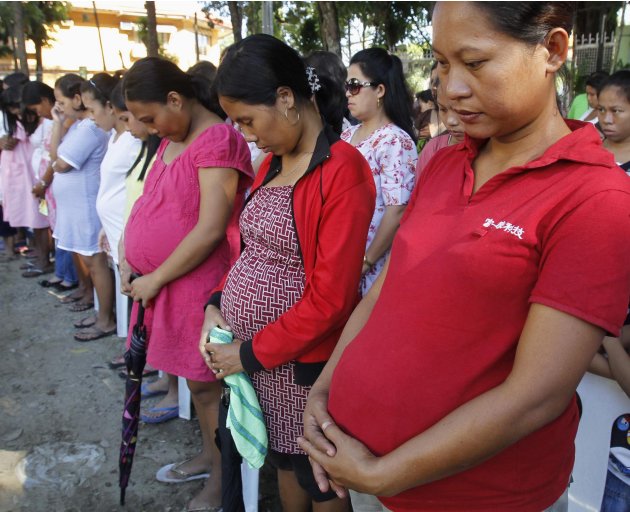 Pregnant Women Pray Before The Start Of A Medical Mission