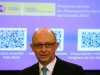 Spain's Treasury Minister Montoro stands in front of a screen showing a document representing the first draft of Spain's 2013 budget, during ceremony at Parliament
