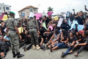 APC party supporters sit on the floor during a march &hellip;