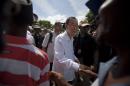 U.N. Secretary-General Ban Ki-moon greets residents during the launching of sanitation campaign in Hinche, Haiti, Monday, July 14, 2014. The Secretary-General arrived in rural Haiti on Monday to help launch a program to improve sanitation and fight the spread of cholera, a disease that many Haitians blame U.N. peacekeepers for introducing to the impoverished Caribbean country. ( AP Photo/Dieu Nalio Chery)