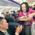 In this March 1, 2012 photo, a passenger buys a meal during the first flight by Peach Aviaction from Osaka, western Japan, bound for Sapporo, northern Japan. Japan has a reputation for loving expensive things like overpriced real estate, gourmet melons and luxury brands. But the nation is finally discovering the joy of flying cheap, with the arrival this year of three low-cost carriers. The takeoff of AirAsia Japan, Peach Aviation and Jetstar Japan could change lifestyles. (AP Photo/Kyodo News) JAPAN OUT, MANDATORY CREDIT, NO LICENSING IN CHINA, FRANCE, HONG KONG, JAPAN AND SOUTH KOREA