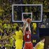 Michigan guard Trey Burke (3) blocks a shot attempt by Ohio State guard Aaron Craft (4) during the overtime period of an NCAA college basketball game at the Crisler Center in Ann Arbor, Mich., Tuesday, Feb. 5, 2013. Michigan defeated Ohio State 76-74. (AP Photo/Carlos Osorio)