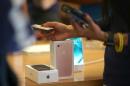 Apple iPhone sales fall but beat estimates; shares slip