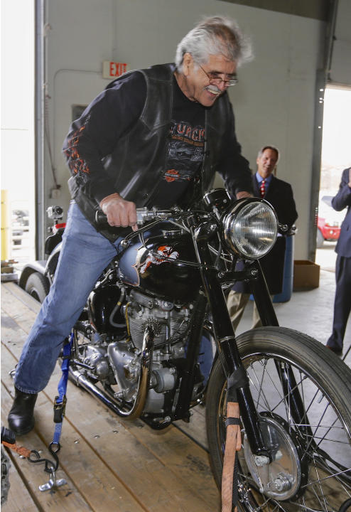 Donald DeVault, 73, gets on his motorcycle in Omaha, Neb., after it was returned to him on Wednesday, Nov. 20, 2013. It was the first time he had seen the bike since it was stolen 46 years ago. Califo