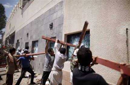 Protesters break the windows of the U.S. embassy in Sanaa