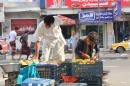 A Yemen boy, right, sells fruits on a street in Taiz city, Yemen, Sunday, May 17, 2015. Hundreds of Yemeni politicians and tribal leaders began talks Sunday in Saudi Arabia on the future of their war-torn country as a five-day humanitarian cease-fire was set to expire, though Shiite rebels there were not taking part. (AP Photo/Abdulnasser Alseddik)