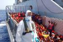 In this Picture released by the Italian Navy, Monday, Aug. 25, 2014, migrants wait to be boarded on the San Giusto Navy ship, along the Mediterranean sea, off the Sicilian island of Lampedusa, Saturday, Aug. 23, 2014. Italian Interior Minister Angelino Alfano renewed his demand for the European Union to relieve pressure on Italy, which has seen some 100,000 migrants arrive so far this year alone. The country says it spends 9.5 million euros ($13 million) a month to operate the beefed-up air and sea patrols that were launched after more than 360 migrants drowned off the Italian island of Lampedusa last October. "Italy will make its own decisions" if EU partners don't offer assistance, he warned in a tweet. The EU's home affairs commissioner, Cecilia Malmstrom, thanked Italy for its "huge efforts" to save lives and said in a statement she would meet Wednesday with Alfano "to better define priorities and provide assistance." (AP Photo/Italian Navy)