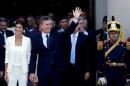 Argentina's President Macri waves alongside First Lady Awada outside Buenos Aires' Cathedral in Buenos Aires