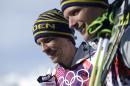 Silver medalist Sweden's Johan Olsson, left, and Sweden's Daniel Richardsson, who took the bronze, pose following the flowers ceremony for the men's 15K classical-style cross-country race at the 2014 Winter Olympics, Friday, Feb. 14, 2014, in Krasnaya Polyana, Russia. (AP Photo/Gregorio Borgia)