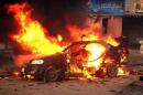 A blaze engulfs a car at the scene of an explosion in the Shiite Muslim Al-Amin district of Baghdad on December 8, 2013