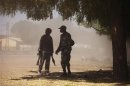 Malian soldiers talk to each other in a cloud of dust during fighting with Islamists in Gao