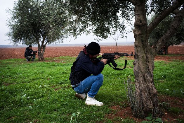 Free Syrian Army fighters aim their weapons, close to a military base, near Azaz, Syria, Monday, Dec. 10, 2012. The gains by rebel forces came as the European Union denounced the Syrian conflict, which activists say has killed more than 40,000 people. (AP Photo/Manu Brabo)