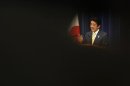 Japan's Prime Minister Abe is seen through reporters as he speaks during a news conference at his official residence in Tokyo