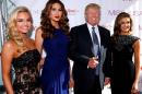 From left, Miss Teen USA 2013 Cassidy Wolf, Miss Universe 2013 Gabriela Isler, Donald Trump, and Miss USA 2013 Erin Brady pose during a red carpet event before the Miss USA 2014 pageant in Baton Rouge, La., Sunday, June 8, 2014. (AP Photo/Jonathan Bachman)