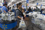 <p>               In this Wednesday, Nov. 22, 2012, photo, Eva Cevallos with her eleven-month daughter, Quinn, shop during the Thanksgiving Pre-Black Friday event at the Walmart Supercenter store in Rosemead, Calif. Wal-Mart Stores Inc. offered a weak business outlook Thursday, Feb. 21, 2013,  as new economic challenges for its low-income U.S. shoppers start to take a toll.  (AP Photo/Damian Dovarganes)