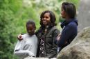 First Lady Michelle Obama with daughters Sasha (L) and Malia (R) during a visit to Glendalough in the Wicklow Mountains National Park in Ireland on June 18, 2013