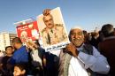 A Libyan carries a portrait of retired general Khalifa Haftar during a rally in support of the rogue former general on May 23, 2014 in Benghazi