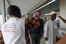 Health workers take passengers' temperatures infrared digital laser thermometers at the Felix Houphouet Boigny international airport in Abidjan