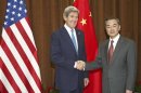 U.S. Secretary of State Kerry is greeted by China's Foreign Minister Wang at the Foreign Ministry in Beijing