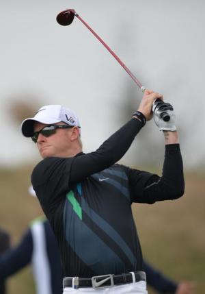 Simon Dyson of England tees off at the second hole …