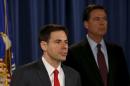 Carlin, flanked by Comey, addresses a news conference to announce indictments on Iranian hackers at the Justice Department in Washington