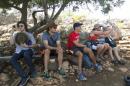 In this 2014 photo provided by Michigan State University, students in the school's Summer Study Abroad Program take a break while hiking in Israel. Some U.S. colleges have now pulled students from their overseas study programs in Israel as the Gaza war rages. Colleges site security as the top concern. (AP Photo/Michigan State University)