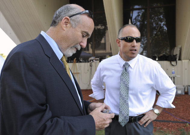 In this Sept. 6, 2012 file photo, Joel Brodsky, left, and Steven Greenberg, attorneys for former Bolingbrook police officer Drew Peterson, confer outside the Will County Courthouse in Joliet, Ill., during the jury deliberations in Peterson's murder trial. The open lawyerly warfare between Brodsky, the lead counsel and co-counsel Greenberg, who also played a central role in the high-profile case, comes to a head Tuesday, Feb. 19, 2013, at a hearing where a judge will decide if Peterson should get a new trial on grounds that the lead trial attorney allegedly did a shoddy job. (AP Photo/Paul Beaty, File)