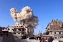 In this image taken from video obtained from the Ugarit News, which has been authenticated based on its contents and other AP reporting, smoke leaps the air from a building after a warplane attack in Homs, Syria, on Wednesday, Nov. 28, 2012. (AP Photo/Ugarit News via AP video)