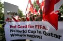 Union members demonstrate outside the headquarters of the world's football governing body FIFA in Zurich on October 3, 2013