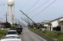 Utility poles are heavily damaged in the aftermath of Isaac as Louisiana Gov. Bobby Jindal's motorcade passes through Grad Isle, La., Friday, Aug. 31, 2012. Isaac is now a tropical depression, with the center on track to cross Arkansas on Friday and southern Missouri on Friday night, spreading rain through the regions. (AP Photo/Gerald Herbert)