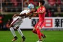 South Korea's Son Heung-Min (R) battles for the ball with Qatar's Pedro Correia during their World Cup qualifier in Suwon on October 6, 2016