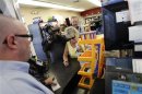 Manager Bob Chebat talks with a woman after checking her Powerball lottery ticket at the 4 Sons Food Store and Chevron gas station which sold one of two winning Powerball lottery tickets in Fountain Hills, Arizona