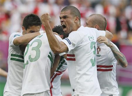 Portugal's Postiga celebrates with Pepe and team mates after scoring second goal during their Group B Euro 2012 soccer match against Denmark at the New Lviv stadium in Lviv