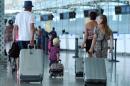 British tourists arrive at the Enfidha International airport in the Tunisian capital Tunis on July 10, 2015 after the British Foreign Office advised tourists that the country was unsafe for holidays