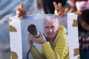 A man holds a picture of Herve Gourdel, the hiker beheaded by Algerian militants linked to the Islamic State group, during a demonstration supporting Kurdish forces fighting the IS in Syria, October 2, 2014 in Marseille, France